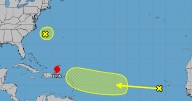 Tropical wave swirls near Africa as Hurricane Erin weakens