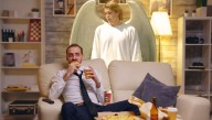 Guardian Angel Dutifully Stands Over Man Watching TV To Make Sure He Doesn't Choke On His Pringles