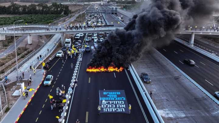Israeli protesters block highway with burning tyres
