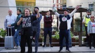 Police officer punched in face as masked protesters with children march through Canary Wharf shopping centre
