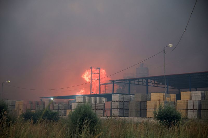 Wildfires fanned by heatwave and strong winds rage across Europe, burning houses and factories