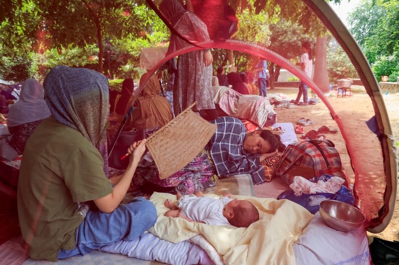 Evicted Afghan refugees huddle in Islamabad park, dreading return home