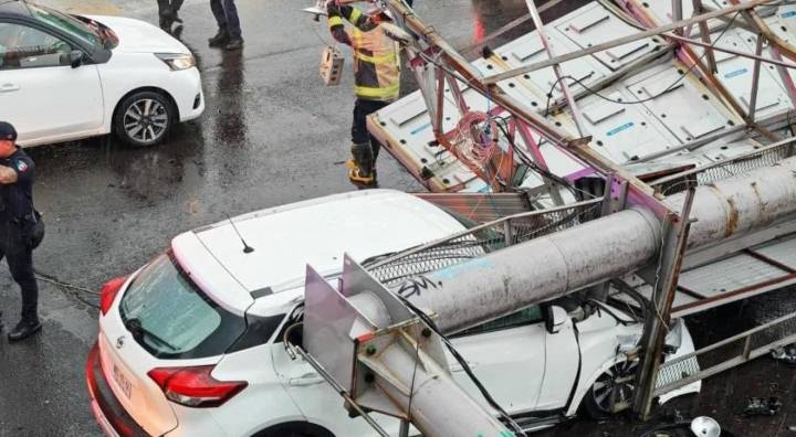 Anuncio espectacular colapsa sobre automóvil con dos pasajeros