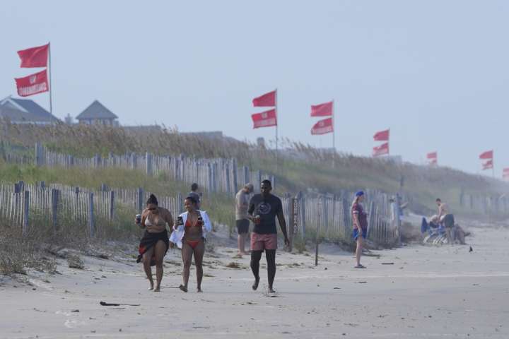 Summer celebrations meet closed beaches and warnings on US East Coast due to Hurricane Erin