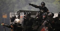 Tensions soar in Serbia as angry protesters clash with police, set fire to party offices