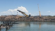 Workers removes debris from Oxbow Bridge fire in Cibola, Arizona