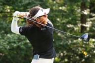 Miranda Wang waits a long time for a short birdie and leads rain