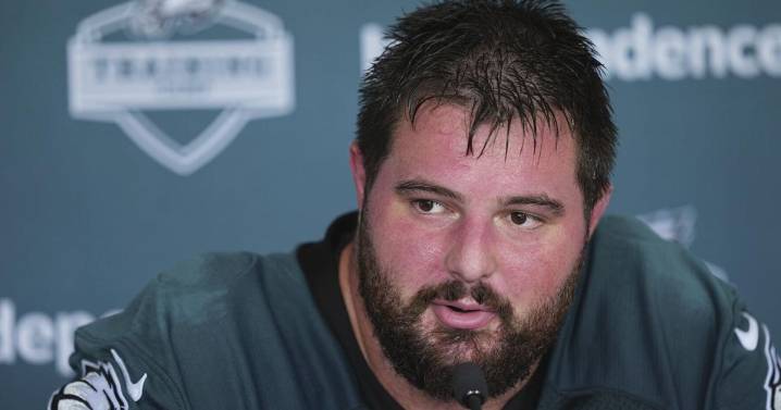 Eagles' Landon Dickerson serves beers at practice while recovering from knee surgery