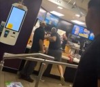 Moment McDonald’s customer climbs over counter and starts fighting staff