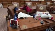 Texas lawmaker refuses police escort, spends to night in the House Chamber, complete with props