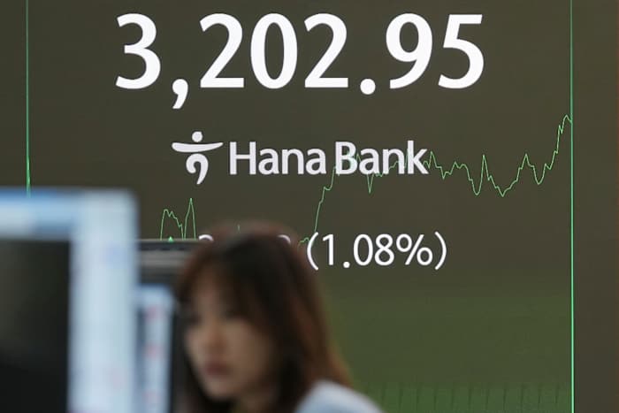 Asian shares track Wall Street's rally after Powell hints at rate cuts