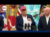 Trump shows off photograph Putin sent him in the Oval Office