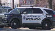 Man shot while driving in Trenton, hits police car, injures pedestrian