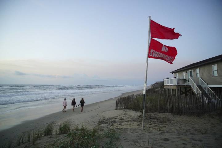 Summer celebrations meet closed beaches and warnings on US East Coast due to Hurricane Erin