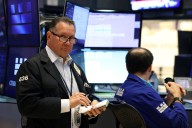 Dow closes up 840 points after Fed chair signals possible interest rate cut