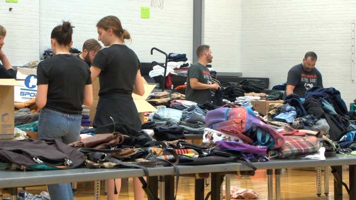 Volunteers sort thousands of items for Youthworks clothing drive