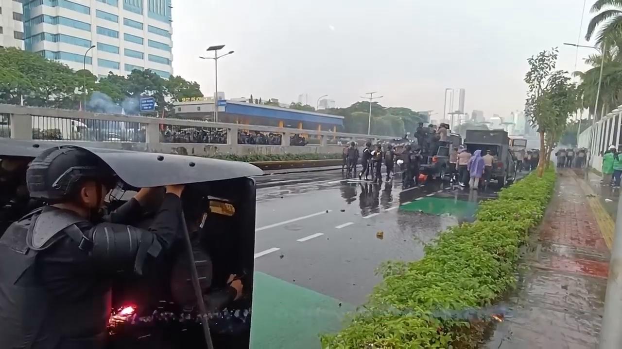 Riot police disperse students protesting lawmakers' privilege in Indonesia