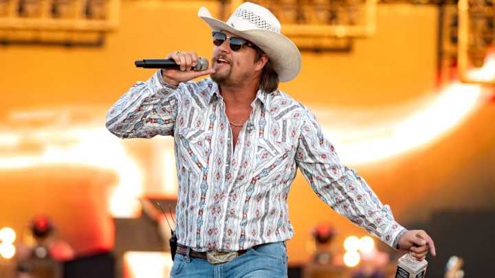 Watch the shock moment security wrestles stage invader to the ground at controversial country singer's gig