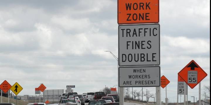 Construction workers assist first responders in helping rollover crash driver