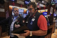 Wall Street holds near its records ahead of earnings from retailers and Fed news