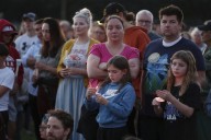 Hundreds honor 2 children killed and 17 people wounded in shooting at a Minneapolis Catholic school