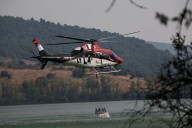 Volunteer firefighter dies as wildfires rage across heat