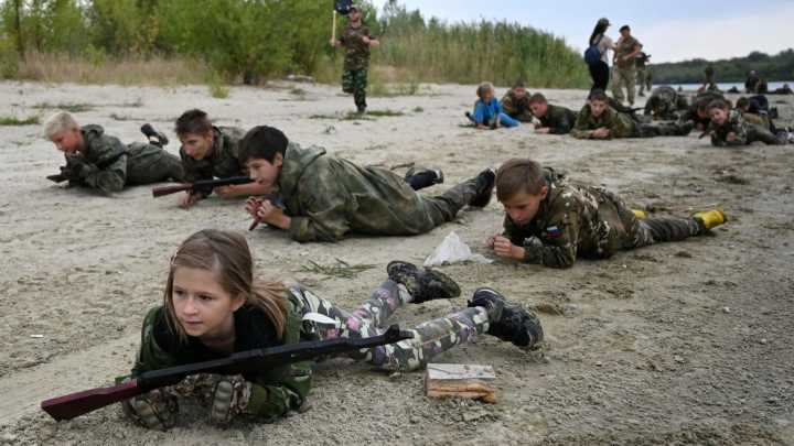 Chilling moment Russian kids crawl with AK-47s & throw grenades as Vladimir Putin prepares his next generation army