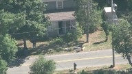 Road closed, investigators seen working at Mass. home