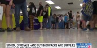 Putnam County School volunteers hand out backpacks and supplies