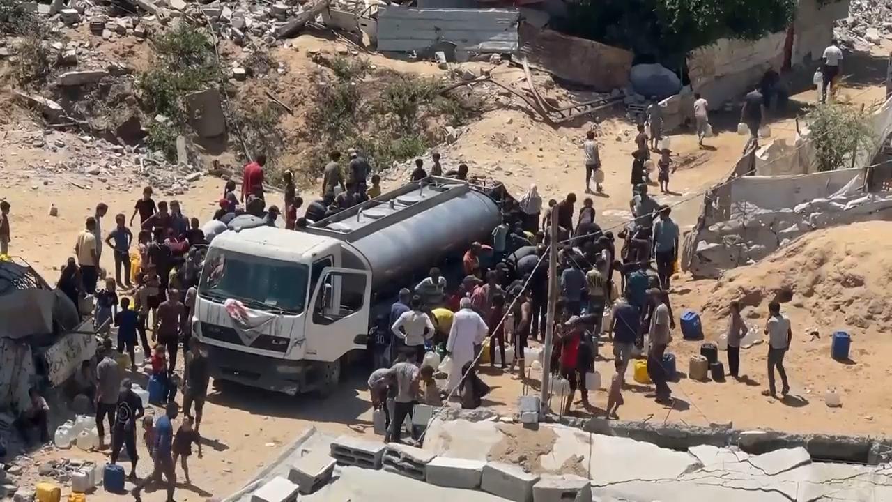 Gaza City residents wait at truck for water after famine declared