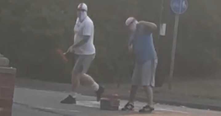 Men in St George's masks filmed painting England flag on Midland roundabout