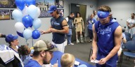 Kids sign autographs for Royals players in role reversal