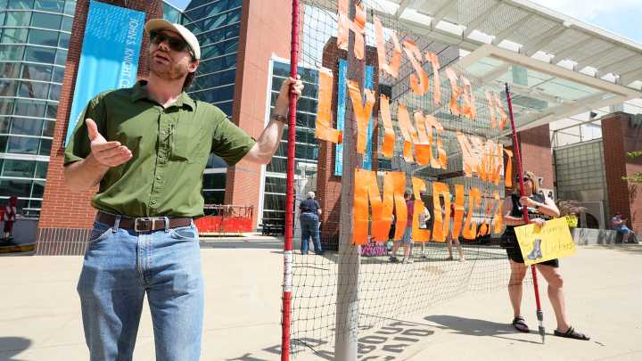 Dozens protest US Senator Jon Husted outside Akron Roundtable talk