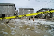 Hurricane Erin stirs up strong winds, floods part of main highway as it creeps along the East Coast