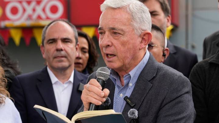 Colombian ex-leader known for contentious war on rebels pays tribute to slain presidential hopeful