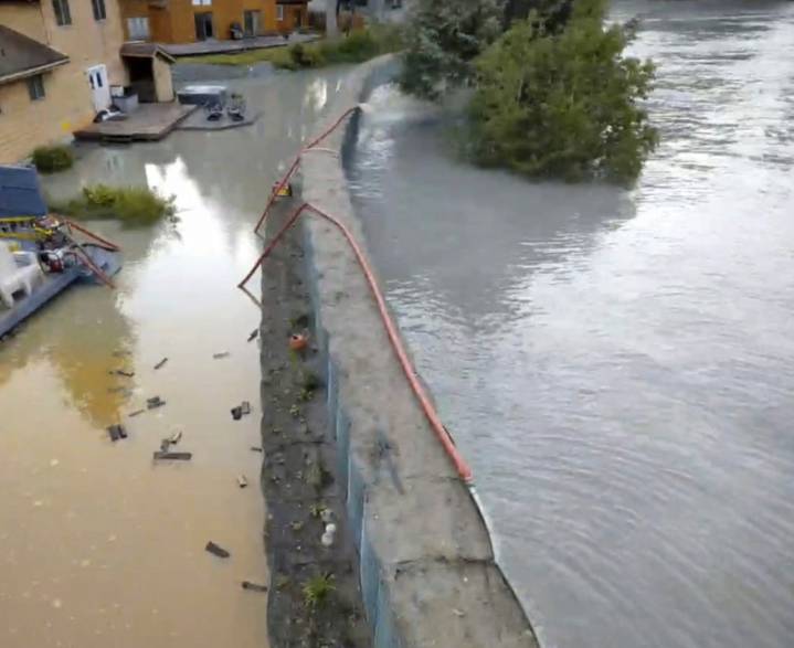 New river barriers prevented severe flood damage from a glacial outburst in Alaska, officials say