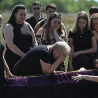 'Back home': family who fled front buried after Kyiv strike