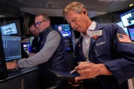 Wall Street ticks toward another record as Tesla vrooms higher