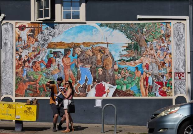 An Oakland mural depicting Native-American genocide was defaced. It led to a debate on the street.