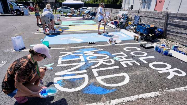 Parking spots used as colorful protest against Florida crackdown on rainbow crosswalks