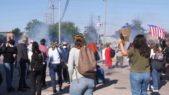 Federal agents fire chemicals as protesters try to block car at immigration site outside Chicago