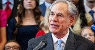 Gov. Greg Abbott signs new bills to improve camp safety as the families of the "Heaven's 27" look on