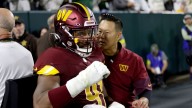 Commanders' Wise carted off field, out for game with quad injury