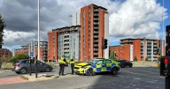 Road blocked after police car crashes on major Manchester roundabout