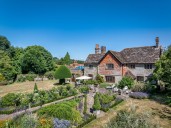 A 500-year-old cottage in West Sussex that's as beautiful as you could ever hope to see, with a pool ringed by flowers, stables and a croquet lawn