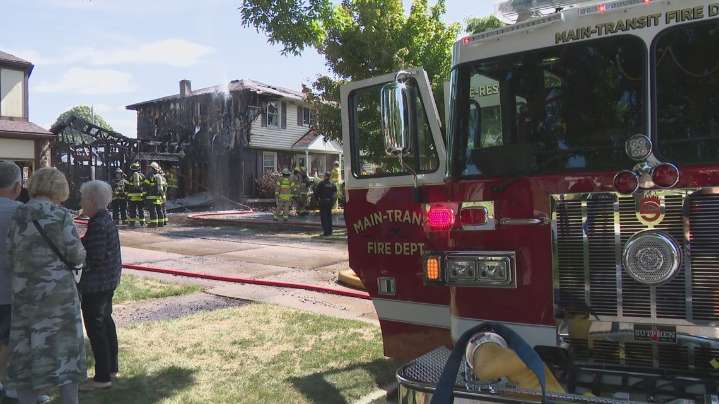 Fast-moving garage fire heavily damages an Amherst home, threatens neighboring house