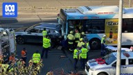 Multiple people hospitalised after bus and car crash on busy M2 in Sydney's north