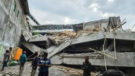 Frantic rescue as school collapses leaving at least one student dead and dozens trapped under the rubble in Indonesia