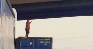 Hero lorry driver stops M1 traffic to save life of man dangling off bridge
