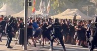 Football fans clash with riot police in ugly scenes ahead of Champions League clash